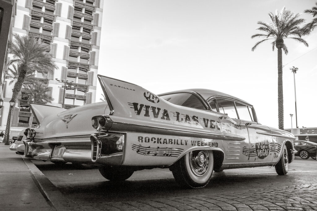 Viva Las Vegas Rockabilly Weekend written the side fin of a vintage car, black and white